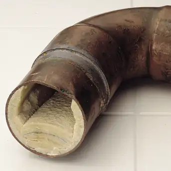 Copper pipe with limescale damage.