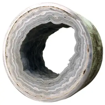 Large pipe showing years of internal limescale buildup.